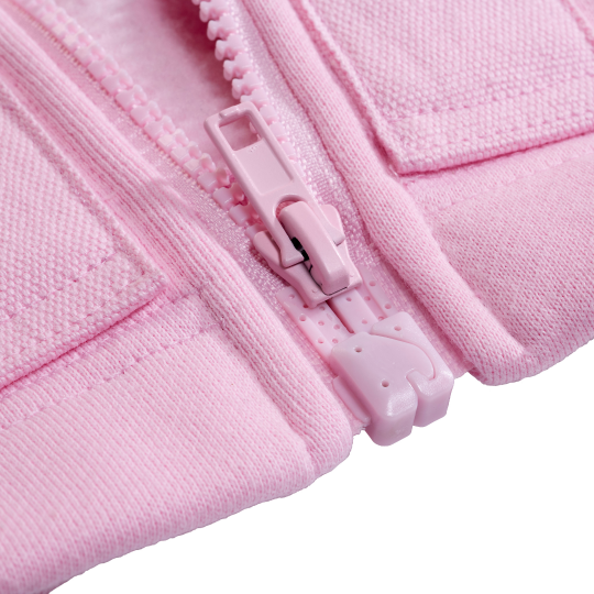Close-up of a pink magnetic zipper on a textured fabric background